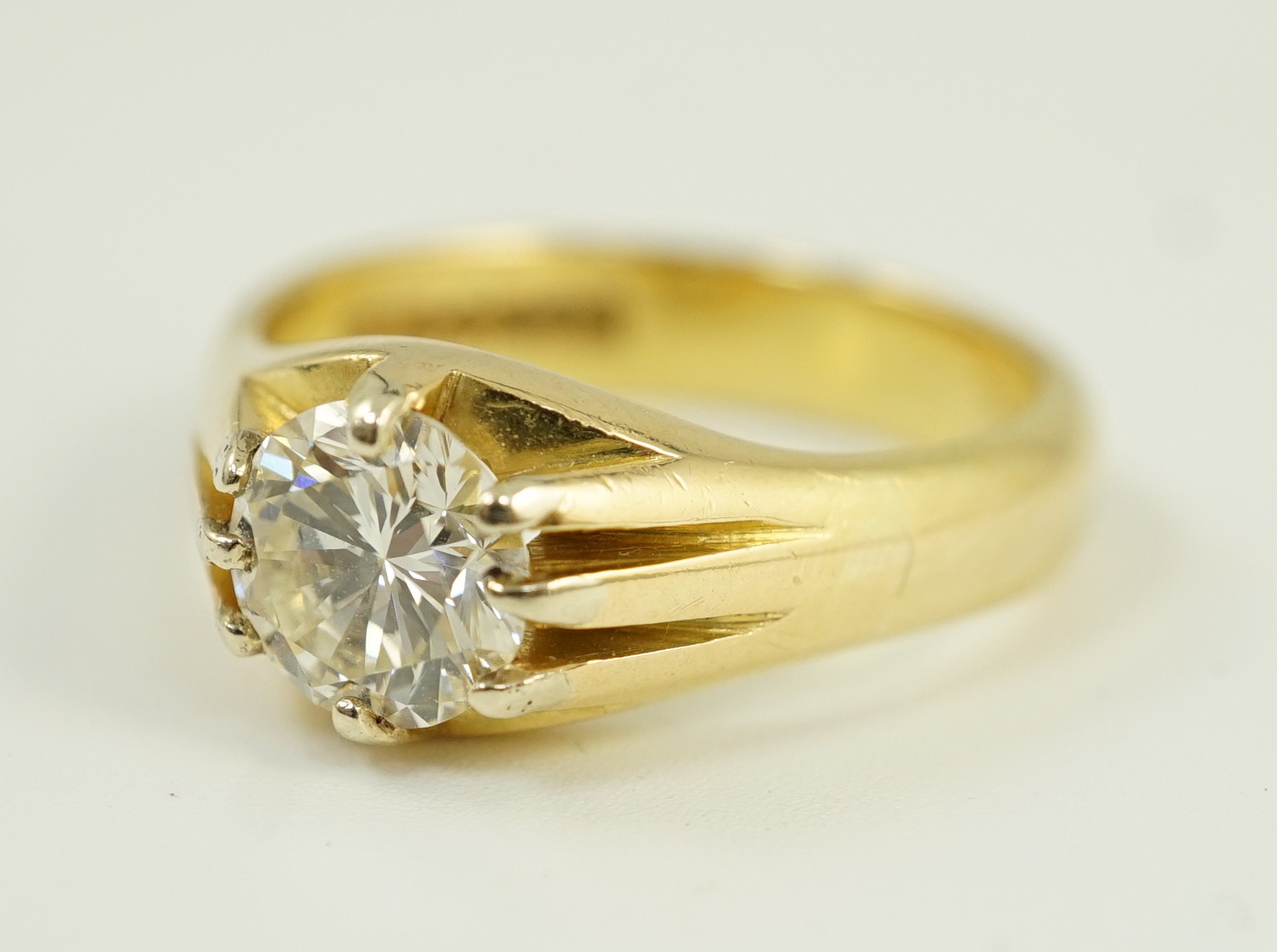 A modern 18ct gold and claw set solitaire diamond ring